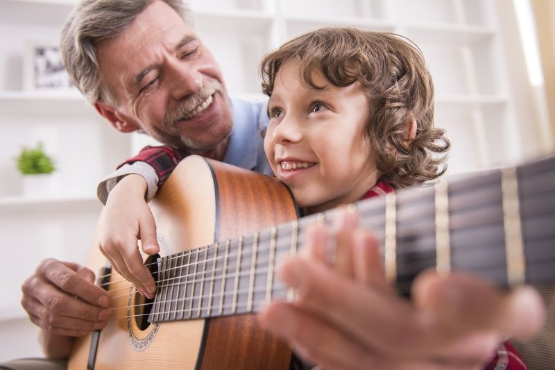 Idoso usando habilidades musicais para garantir renda extra ensinando
